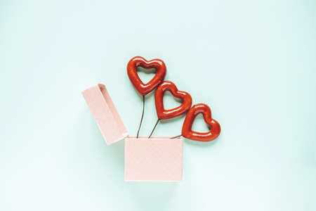 Hearts in a box on a pastel blue background. Holidays concept. Flat lay, top view, copy space. Valentine's Day background. の写真素材