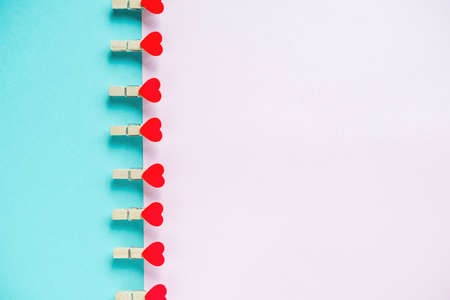 Hearts on pastel blue and pink background. Valentines day concept. Flat lay, top view, copy space. Valentine's Day background. の写真素材