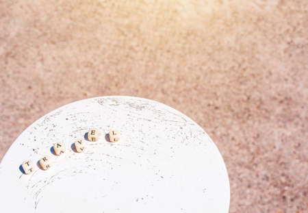 Word Travel on the background of the sea. Letters on wooden cubes on white and sand backgrounds.の写真素材