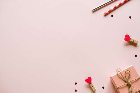 Valentine's day background. Top view, shot from above. Gift boxes, straws, hearts, confetti and...