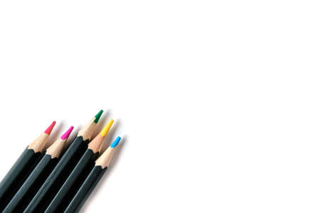 Colored pencils on white isolated background. Bright colors and pencils in black designの写真素材
