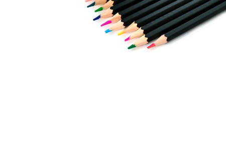 Colored pencils on white isolated background. Bright colors and pencils in black designの写真素材