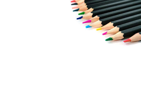 Colored pencils on white isolated background. Bright colors and pencils in black designの写真素材