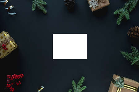Christmas background with frame and place for text. Dark New Year background with spruce branches, gift boxes and streamers. Copy space, flat layの写真素材