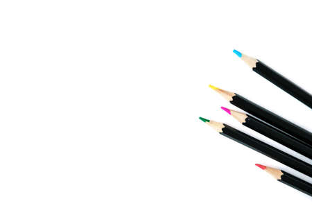 Colored pencils on white isolated background. Bright colors and pencils in black designの写真素材