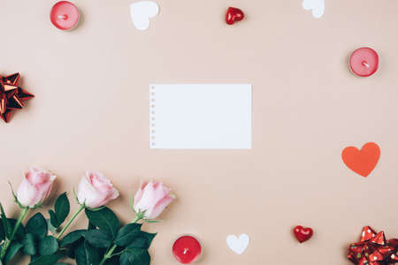 Delicate beige background for Valentine's day with roses, hearts, bows and candles. Romantic postcardの写真素材