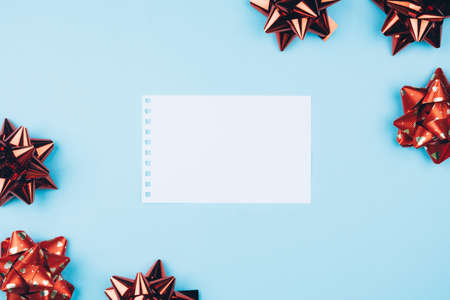 Delicate blue background with red bows and space for text.