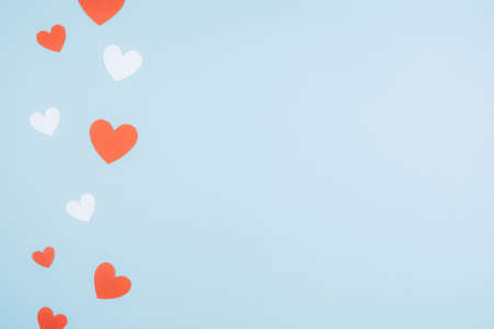 Blue background with red and white paper hearts. Space for textの写真素材
