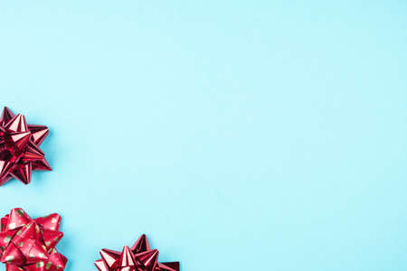 Gift red bows on a blue background. The concept of the celebration and gifts.の写真素材