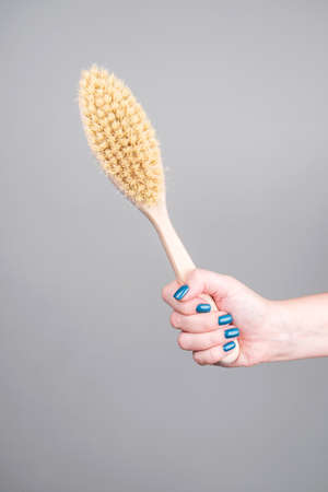 Natural bristle massage brush on a grey background.の写真素材