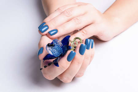 Beautiful women's hands with well-groomed blue manicureの写真素材