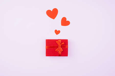Gift box and hearts on a soft pink background. Postcard for the belovedの写真素材