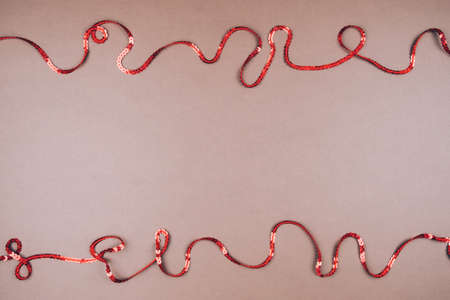 Brown background for Valentines day with a ribbon of sequins, space for text.の写真素材