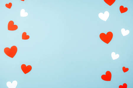 Minimalistic blue background for Valentine's day with paper hearts. Space for textの写真素材
