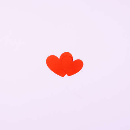 Two red hearts on a pink background. Postcard for beloved, the concept of the relationshipの写真素材