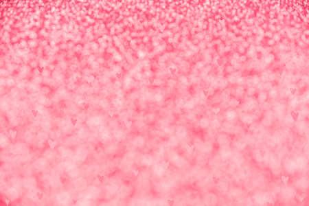 Red background with sequins out of focus. Background for Valentine's day. Beautiful packaging with hearts for a holidayの写真素材