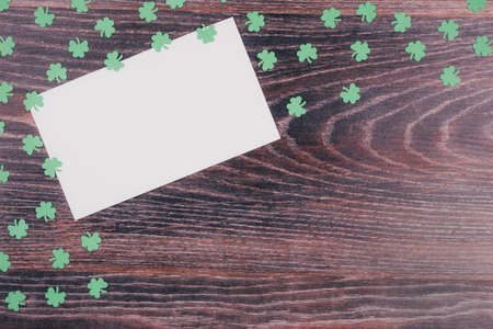 Green clover leaves on a wooden background. Background for St. Patrick's Day. Space for text. Paper decorationsの写真素材