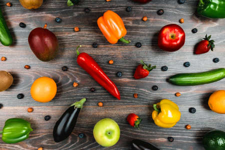 Vegetables and fruit are on a dark wooden table. Background of healthy food productsの写真素材