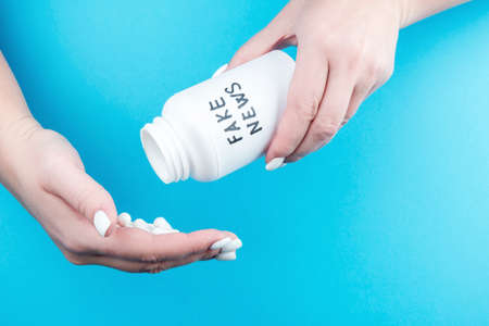 A jar of truth pills in a womans hands. The concept of distorted information from the mediaの写真素材