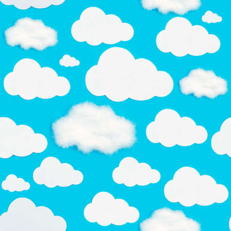 A pattern of cut-out white clouds on a blue background. Be different, be uniqueの写真素材