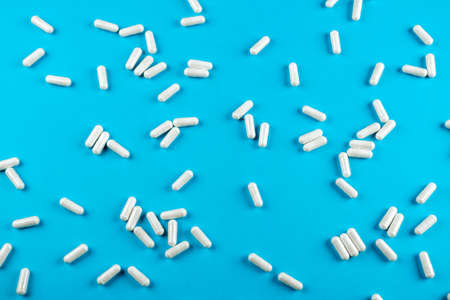 White tablets on a blue background with space for textの写真素材