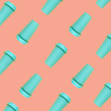 Turquoise bamboo coffee mug on a coral background without shadows in pattern. Environmental consumption, care for the world, recycling. Isolateの写真素材