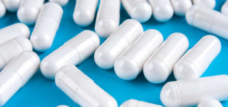 Banner with white tablets on a blueの写真素材