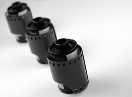 lack & White Image of unexposed 35mm film rolls. Three in a line, shallow depth of field with focus on first roll.の写真素材