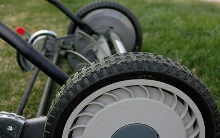Old style push reel mower.  Mower photographed dirty to show extended use.  Perspective shot of...
