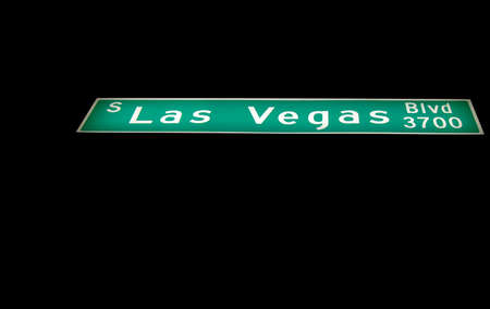 Perspective image of illuminated Las Vegas Boulevard street sign against black night background.の写真素材
