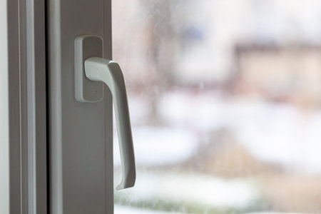 Closed white plastic pvc window in winter on a cloudy day.の写真素材