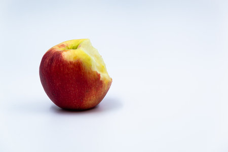 Red bitten apple on white background with shadow