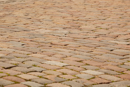 Street pavement texture in tiles. Gray rectangular old tiles. For text. Background. Horizontal.
