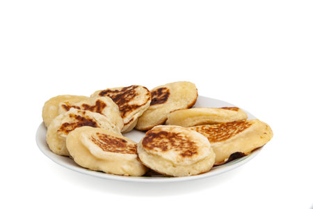Delicious country breakfast, fried pancakes in a plate with a fork on a white background.の写真素材