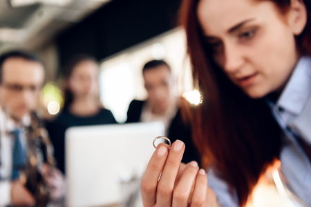 Concept of deprivation of rights to child custody. Family in office of family lawyer. Oppressed mother, deprived of rights to guardianship of child, sits in office of lawyer.の写真素材