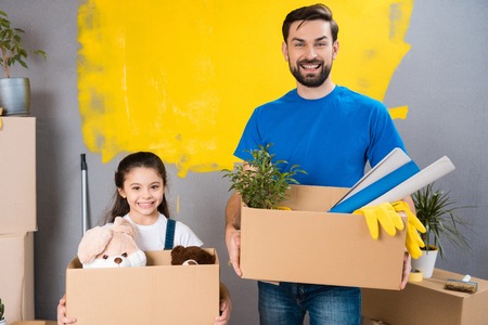 Young father and little daughter are planning to make house repair. Preparation house for sale. Overhaul of house. Moving to new apartment.の写真素材