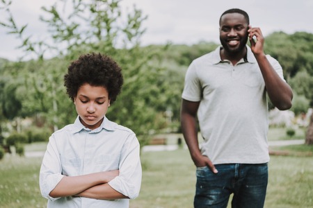 Father with son in park. Son upset. Family relations concept.の写真素材