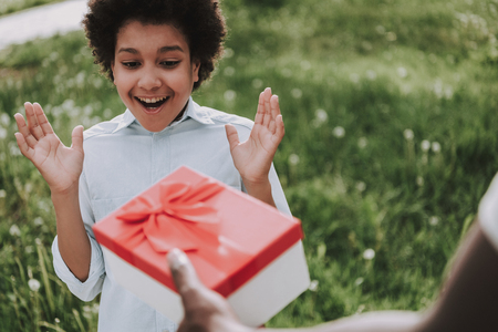 Father makes surprise to son in park. Present concept.の写真素材