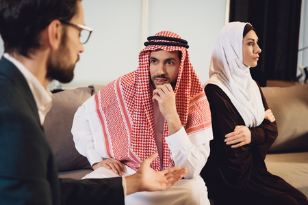 Arab married couple in quarrel at psychologist reception. Visit to family psychologist. Family psychotherapy concept.の写真素材