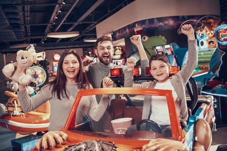 Happy family in amusement center. Family rest, leisure. Spending holiday together with family. Entertainment center, mall, amusement park.の写真素材