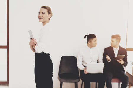 Woman in shirt looks to the side and smiles.の写真素材