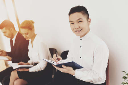 A man in a shirt looks at the camera and writes.の写真素材