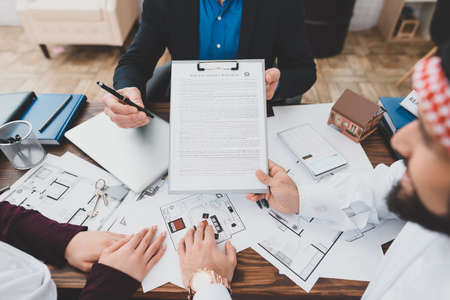 Arab holds a contract in his hands.