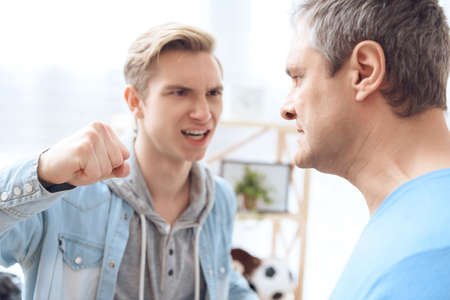 The evil son swung his fist at his father and wants to hit him.