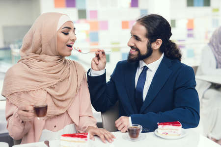 Arabian Couple Sitting in Cafe after Shopping.の写真素材