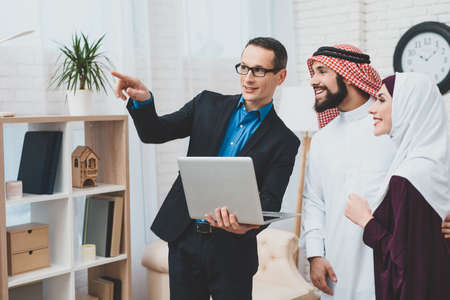 Adult male realtor with a laptop in his hands.の写真素材