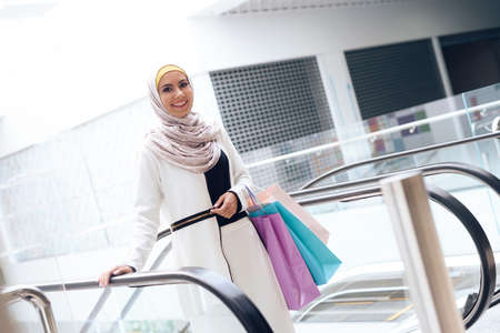 Young Arabian Woman with Packages Standing in Mallの写真素材