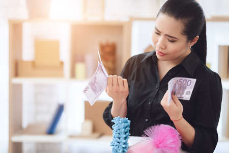 Housekeeper received payment for her labor.の写真素材