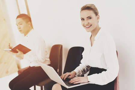 A man next to a woman writes something.の写真素材