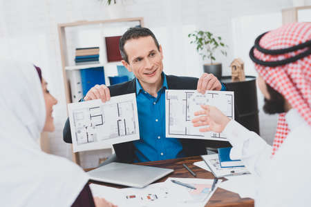 Arab man shows on the plan of the apartment.の写真素材